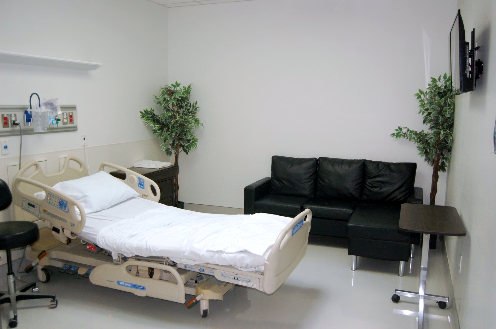 A private patient room with family seating at Fountain Hills Emergency Room.